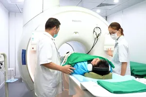 Doctors in Cho Ray Hospital are preparing to perform a CT scan on a patient