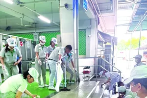 Workers of Nidec Vietnam Co. Ltd. (sited in Saigon Hi-tech Park) are cleaning their workplace to increase safety