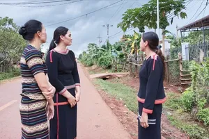 Residents of Nu Village (Ia Nan Commune of Gia Lai Province) rejoice beside the solar power system built by Economic-Defense Group 72 
