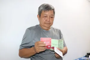 Mr. Nguyen Hoa with his card confirming his 131st blood donation