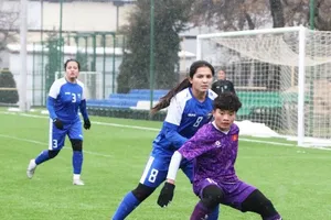 Ngọc Minh Chuyên tranh bóng cùng cầu thủ đội chủ nhà