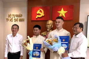 Lê Giang Patrick và Khoa Ngo nhận quyết định từ lãnh đạo Sở Tư pháp TPHCM.