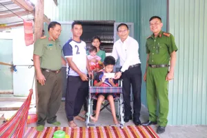 Trao tiền bạn đọc hỗ trợ cho cháu bé bại não ở Gia Lai