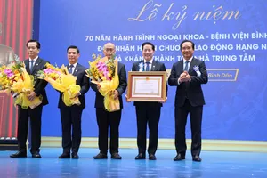 Đồng chí Nguyễn Văn Được, Chủ tịch UBND TPHCM gắn Huân chương Lao động hạng Nhì lên cờ truyền thống Bệnh viện Bình Dân