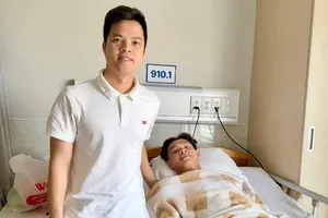 Bác sĩ Trần Huy Thọ của đội tuyển Việt Nam thăm tiền đạo Bùi Vĩ Hào sau ca phẫu thuật.