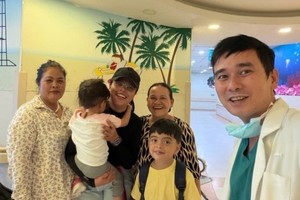  陈功保凤医生（右）与患儿家属共同分享康复的喜悦。 