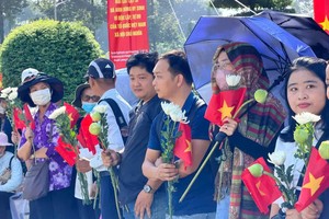 大批民众聚集在胡志明市烈士陵园门口，等候迎接烈士遗骸前来安息。图：黄雄