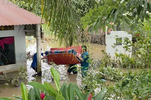 Lượng lượng chức năng giúp người dân di chuyển đồ ra khỏi căn nhà bị ngập