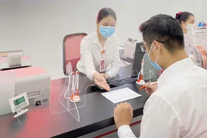 Khách hàng giao dịch tại ngân hàng.  Ảnh: Minh Huy