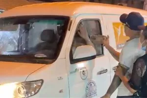 Hình ảnh người đàn ông cầm đá đập vào xe ô tô 