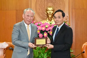 胡志明市市委书记陈留光向太平洋建设集团董事局主席严介和赠送纪念品。