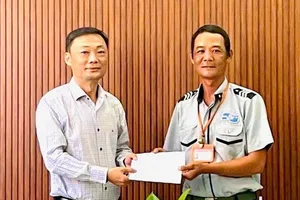 Ông Nguyễn Đức Vũ, Trưởng ban Ban quản lý bán đảo Sơn Trà và các bãi biển du lịch Đà Nẵng khen thưởng đột xuất cho anh Phan Thanh Trinh, Tổ trưởng Tổ công tác số 2