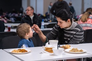 圖為在波蘭華沙，一名烏克蘭婦女在餵自己的孩子吃飯。（圖：新華社）
