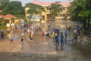 洪水退後，峴港市麗水縣各所學校的工作人員配合有關部門力量進行清潔校園。（圖：VOV）