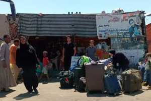 逃离苏丹的难民抵达埃及南部阿斯旺省的一处汽车站。（图片来源：新华社）