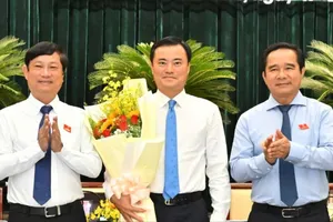 Chủ tịch UBND TPHCM Nguyễn Văn Được và Chủ tịch HĐND TPHCM Võ Văn Minh tặng hoa đồng chí Bùi Xuân Cường sau khi HĐND TPHCM biểu quyết miễn nhiệm chức danh Phó Chủ tịch UBND TPHCM để thực hiện công tác cán bộ. 