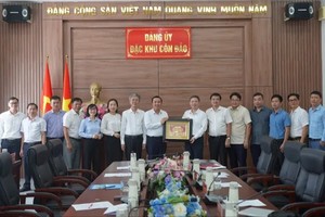 胡志明市市委宣教与民运处主任杨英德和工作团向崑崙岛特区党委赠送纪念品。