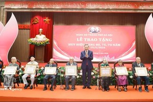 党中央总书记、国家主席苏林向各位党员颁发党龄纪念章。图：越通社