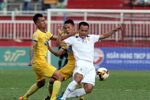 Tiến Thành (Thanh Hóa, bên trái) cản đường tấn công của Quang Vinh (TPHCM). Ảnh: DŨNG PHƯƠNG