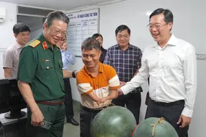 Đồng chí Lê Quốc Phong (ngoài cùng bên phải) cùng PGS-TS-BS Nguyễn Hồng Sơn thăm hỏi bạn trẻ tại Hội nạn nhân chất độc da cam/dioxin TPHCM. ẢNH QUANG HUY