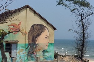 A portrait of a girl is painted on the wall of a house in Tam Thanh village in Quang Nam (Photo: VNA)