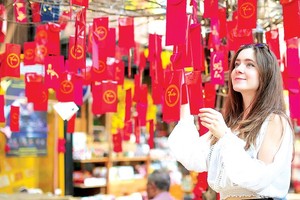 A Danish student chooses New-Year greeting cards in Nguyen Van Binh Book Street in HCMC.