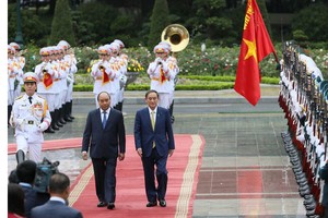 Japanese Prime Minister Yoshihide Suga gets a red carpet welcome.