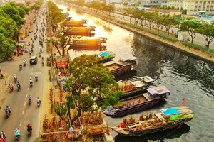 Boats filled with ornamental trees and flowers gather at Binh Dong wharf.