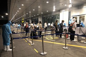 Passengers get health checks at Van Don International Airport.