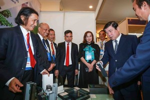 Chairman of HCMC People's Committee Nguyen Thanh Phong (2nd, R) and overseas Vietnamese at the meeting in 2020