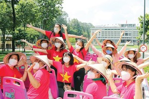 Tourists take double-decker bus tour to explore the city's sights.