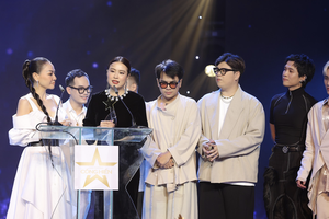 Hoang Thuy Linh (3rd, L), Khac Hung (2nd, L) and the DTAP at the awarding ceremony of Devotion Music Awards 2023 (Photo: SGGP)