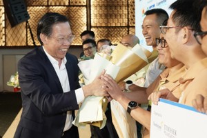 Chairman of the HCMC People’s Committee Phan Van Mai congratulates the winners. (Photo: SGGP)
