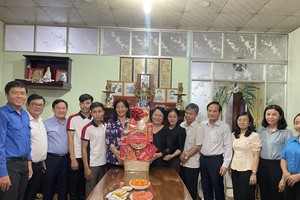 Deputy Head of the HCMC Party Committee's Commission for Mass Mobilization Nguyen Thi Bach Mai (6th, L) leads a delegation to visit the family of Ms. Kieu Nguyet Hong Lien in Binh Chanh District. (Photo: SGGP)