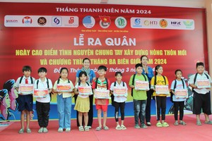 Offering health insurance cards to disadvantaged students of the Ca Gang Primary and Secondary School in Binh Phu Commune in Dong Thap Province’s Tan Hong District on March 17 (Photo: SGGP)