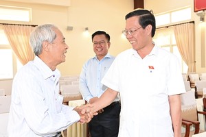 Chairman of the HCMC People’s Committee Phan Van Mai (R) meets voters at the meeting. (Photo: SGGP)