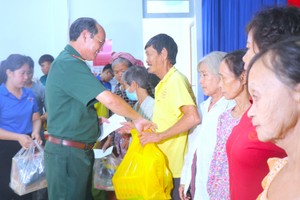 Lieutenant General Nguyen Van Nam, Commander of the HCMC High Command cum President of the HCMC Vietnam - Cambodia Friendship Association offers gifts to needy people. (Photo: SGGP)