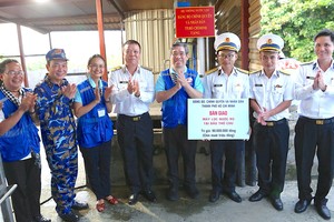 Vice Secretary of the HCMC Party Committee cum Chairman of the Vietnam Fatherland Front Committee of HCMC Nguyen Phuoc Loc (4th, R) and delegates offer water purifiers to soldiers of the Radar Station 610. (Photo: SGGP)