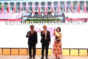 Vice Chairman of the Ho Chi Minh City People’s Committee Nguyen Manh Cuong (L) extends his congratulations on the occasion of the 60th National Day of Singapore. (Photo: SGGP)