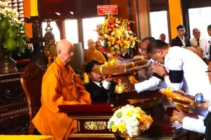 Thai Vice Minister for Foreign Affairs Vijavat Isarabhakdi presents the Royal Kathina Robe to Most Venerable Thich Tri Quang. (Photo:SGGP)