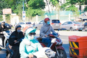 Residents in HCMC bundle up as temperatures dip. 