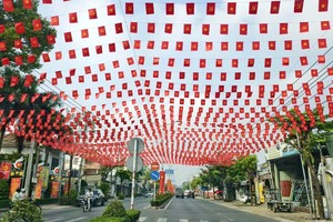 Phu Loi Street in Phu Loi Ward is brightly adorned with flags and flowers. (Photo: SGGP)