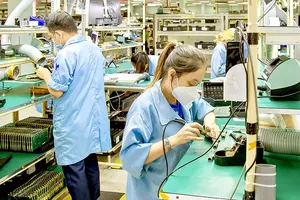 Workers operate on an electronic equipment production line at Datalogic in the Saigon Hi-Tech Park. (Photo: SGGP)