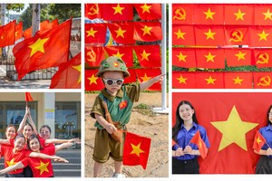 Major streets in central Ho Chi Minh City covered in red flags with yellow stars