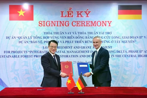 Deputy Minister of Finance Tran Quoc Phuong (left) and a representative of the German Reconstruction Bank (KfW) sign a loan agreement and a grant agreement for the two projects at a ceremony in Hanoi on July 23. (Photo: Ministry of Finance)