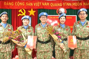 Flowers presented to congratulate the two newly admitted Party members. (Photo: Vietnamese peacekeeping forces)