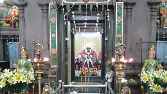 In the center is the shrine of the Goddess Mariamman and in a relief above the shrine the goddess is seated with the gods Ganesha and Naaga on either side.