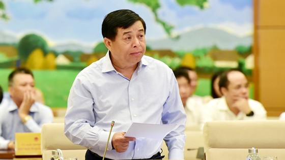 Bộ trưởng Bộ KH-ĐT Nguyễn Chí Dũng trình bày báo cáo về kinh tế - xã hội. Ảnh: TTXVN