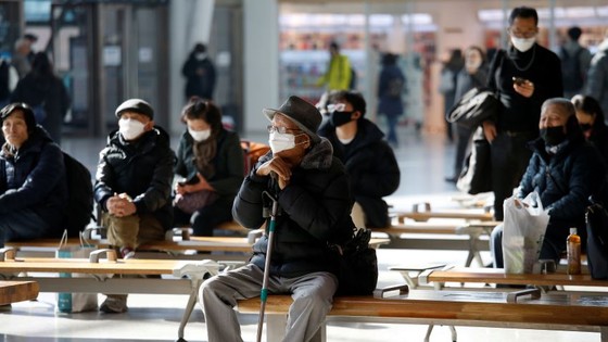 People wear masks at Seoul Station. South Korea has seen a surge in coronavirus cases.