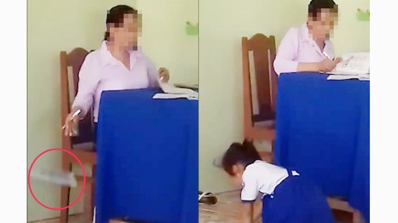 Cô giáo chấm bài xong rồi "thả" xuống nền gạch, học sinh chạy lên nhặt đem về. Ảnh cắt từ clip